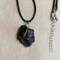 Lump of black obsidian, tied with copper, crosses in the front